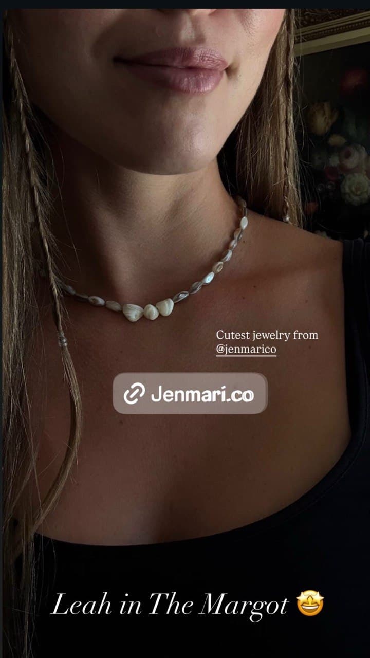 Shell-pearl Margot necklace styled against a black top