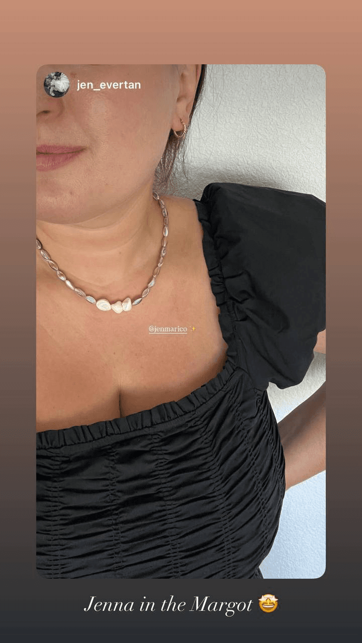 The Margot shell-pearl necklace worn with a black puff-sleeve dress